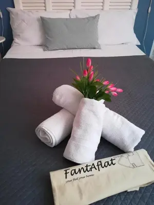 a pair of towels and a plant on a bed at FantAflat in Rome
