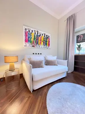 a living room with a white couch and a table at Casa di Gianni in Rome