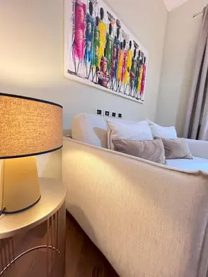 a bedroom with a bed and a table with a lamp at Casa di Gianni in Rome