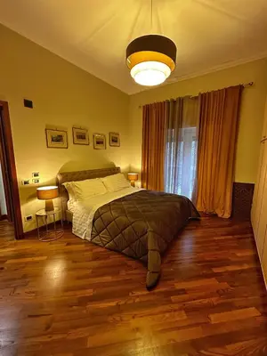 a bedroom with a bed and a light at Casa di Gianni in Rome