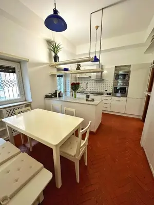 a kitchen with a white table and chairs in it at Casa di Gianni in Rome