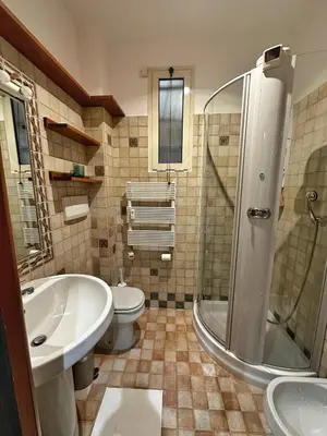 a bathroom with a tub and a toilet and a sink at Casa di Gianni in Rome