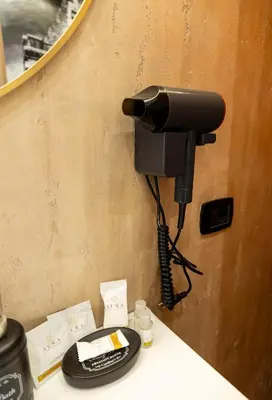 a phone is hanging on a wall at Liu Home Tiburtina Stay in Rome in Rome