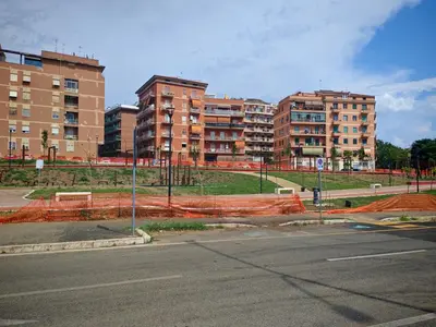 an empty street with apartment buildings in the background at Liu Home Tiburtina Stay in Rome in Rome