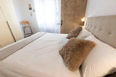 a large white bed with two pillows on it at Liu Home Tiburtina Stay in Rome in Rome