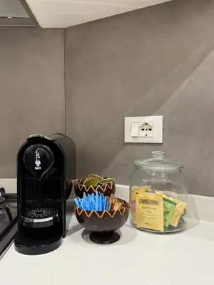a kitchen counter with a toaster and a bowl of food at Exclusive Apartment in the Heart of Rome in Rome