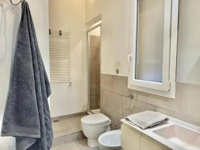 a bathroom with a toilet and a sink at Exclusive Apartment in the Heart of Rome in Rome