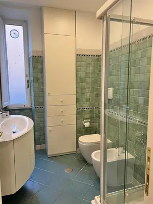 a bathroom with a toilet and a sink and a shower at Domus Dolce Vita - Apartment in Rome