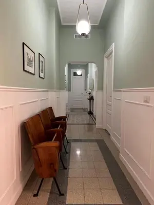 a hallway with two chairs and a white door at Domus Dolce Vita - Apartment in Rome