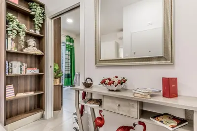 a living room with a mirror and a table at White Living R-home in Rome