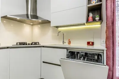 a kitchen with white cabinets and a sink at White Living R-home in Rome