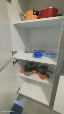 a white shelf with bowls and dishes on it at White Living R-home in Rome