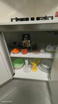 a toy shelf with plates and other items on it at White Living R-home in Rome