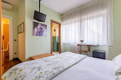 a bedroom with a large bed and a window at Notte al Vaticano in Rome