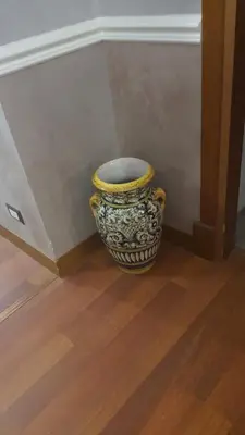 a large vase sitting on the floor next to a wall at Sandel Giubileo Hotel in Rome