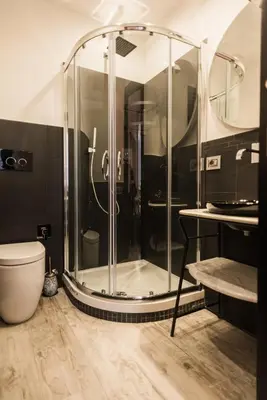 a glass shower in a bathroom with a toilet at Trevi & Pantheon Luxury Rooms in Rome