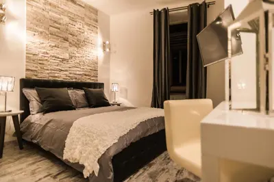 a bedroom with a bed and a brick wall at Trevi & Pantheon Luxury Rooms in Rome