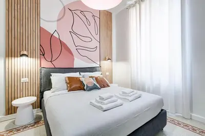 a bedroom with a bed with towels on it at BDC - Termini Dreaming 3-BDR in Rome