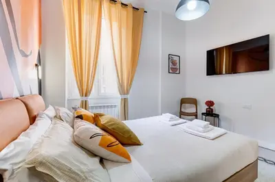 a bedroom with a bed with pillows and a window at BDC - Termini Dreaming 3-BDR in Rome