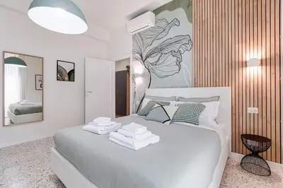 a bedroom with a white bed with towels on it at BDC - Termini Dreaming 3-BDR in Rome