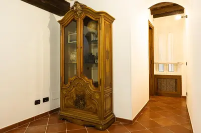 an old wooden grandfather clock in a room at Domus LXVII Monti in Rome