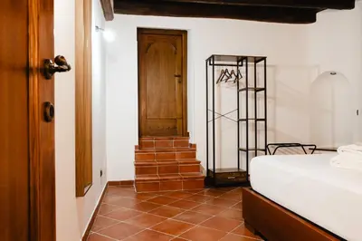 a room with a bed and a wooden door at Domus LXVII Monti in Rome