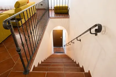 a staircase in a house with a yellow couch at Domus LXVII Monti in Rome