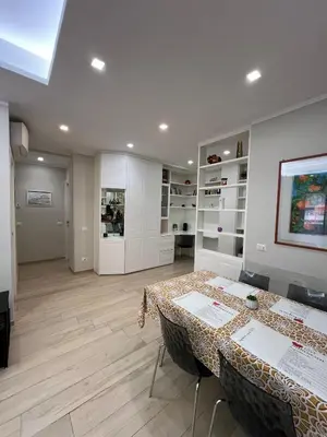 a room with two tables and a room with shelves at Cami Luxury Flat Rome in Rome