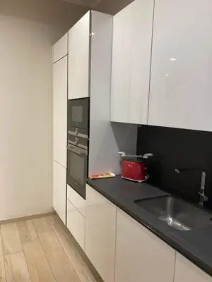 a kitchen with white cabinets and a sink at Cami Luxury Flat Rome in Rome