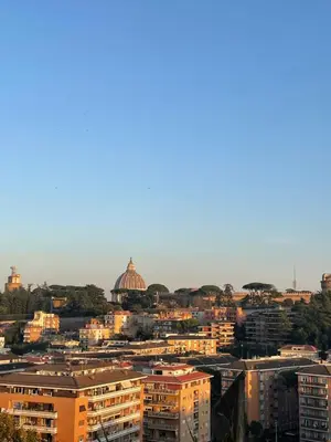 a city with buildings and a dome in the distance at Cami Luxury Flat Rome in Rome
