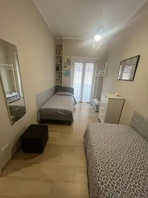 a room with two beds and a mirror at Cami Luxury Flat Rome in Rome