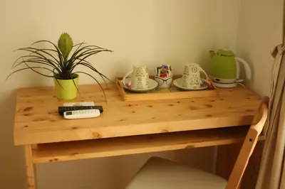 a wooden table with cups and saucers on it at B&B Alle Porte di San Giovanni in Rome