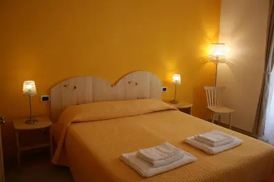 a bedroom with a bed with two towels on it at B&B Alle Porte di San Giovanni in Rome