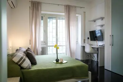 a living room with a green couch and a window at Marconi Suites in Rome