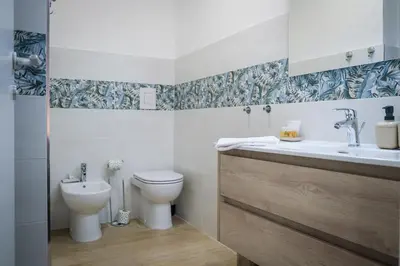 a bathroom with a toilet and a sink at Marconi Suites in Rome