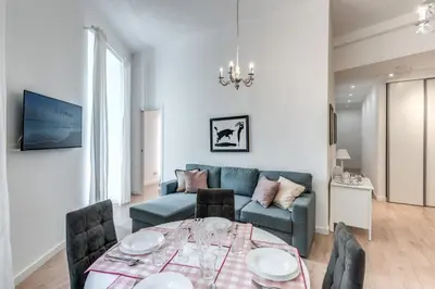 a living room with a table and a couch at Fresh House Vaticano in Rome