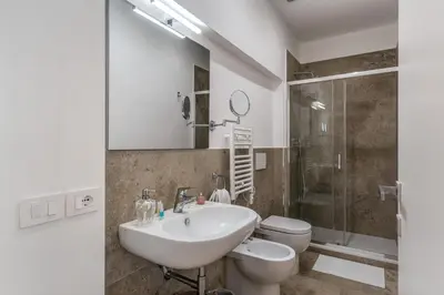 a bathroom with a sink and a toilet and a shower at Fresh House Vaticano in Rome