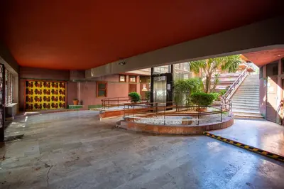 an empty lobby of a building with benches and stairs at Stanza Comoda e Silenziosa con Bagno Privato e Area Lavoro e Relax in Rome