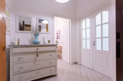 a room with a dresser with a vase on it at Stanza Comoda e Silenziosa con Bagno Privato e Area Lavoro e Relax in Rome