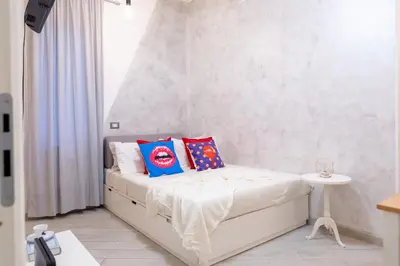 a bedroom with a bed with two pillows on it at Stanza Comoda e Silenziosa con Bagno Privato e Area Lavoro e Relax in Rome