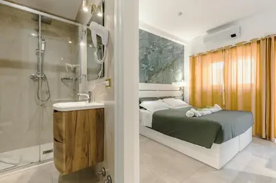 a bathroom with a bed and a shower and a sink at Perfect! Vatican Location in Rome