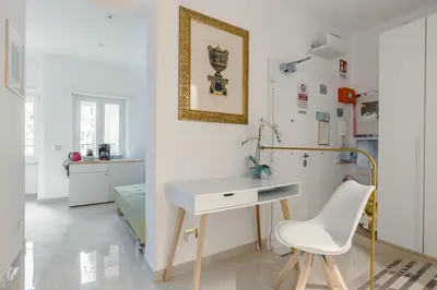 a white desk and a chair in a room at Perfect! Vatican Location in Rome