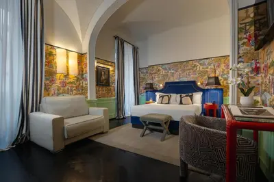 a bedroom with a bed and a chair and a couch at V Collection Condotti in Rome