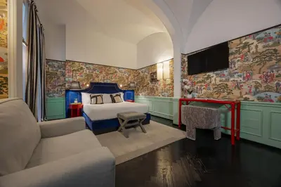 a bedroom with a bed and a tv and a couch at V Collection Condotti in Rome