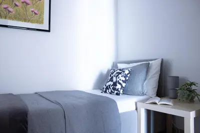 a bedroom with a bed and a table with a pillow at Tommys flat by DomusDimore in Rome