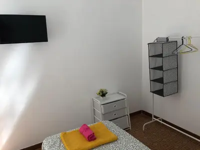 a bedroom with a bed and a dresser and a tv at LoL Apartment in Rome