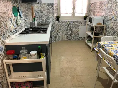 a kitchen with a stove and a counter top at LoL Apartment in Rome