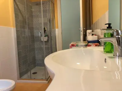 a bathroom with a sink and a glass shower at LoL Apartment in Rome