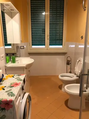 a bathroom with a toilet and a sink at LoL Apartment in Rome