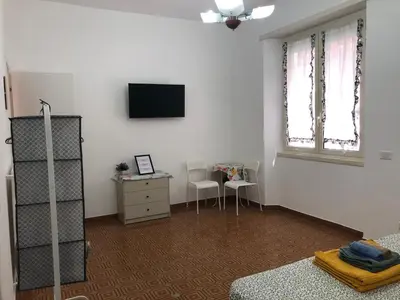 a room with a tv and a desk and a chair at LoL Apartment in Rome